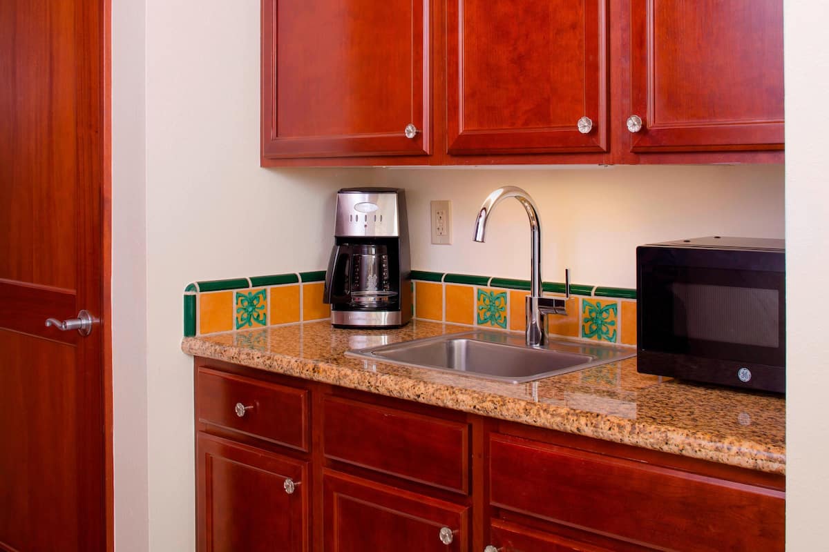 Fridge, microwave, coffee/tea maker, cookware/dishes/utensils
