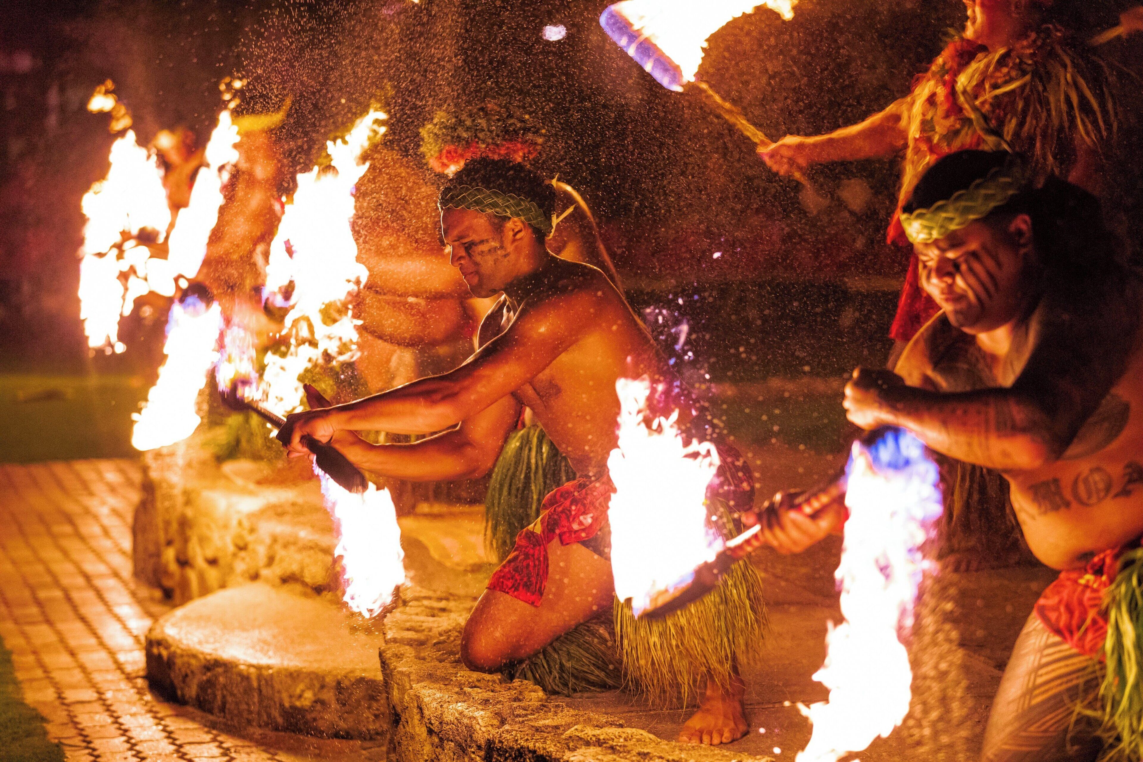 A person performing a fire ritual with flames.