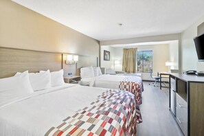 A hotel room with two beds, a desk, a chair, a TV, and a window with curtains. - Red Roof Inn & Suites Fayetteville - Fort Bragg (Fayetteville)