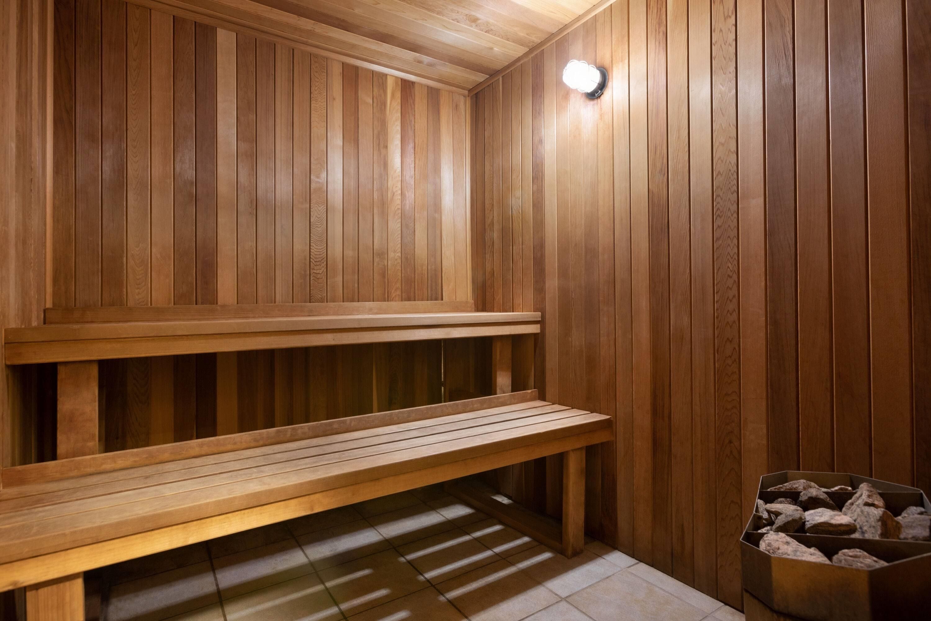 A sauna with wooden benches and a tiled floor.