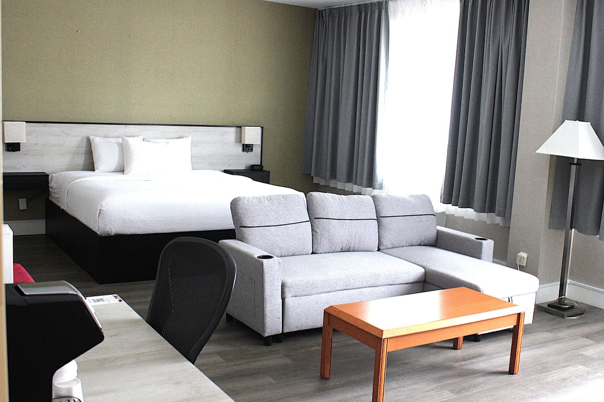 Suite, 1 King Bed, Non Smoking | Desk, laptop workspace, blackout drapes, iron/ironing board