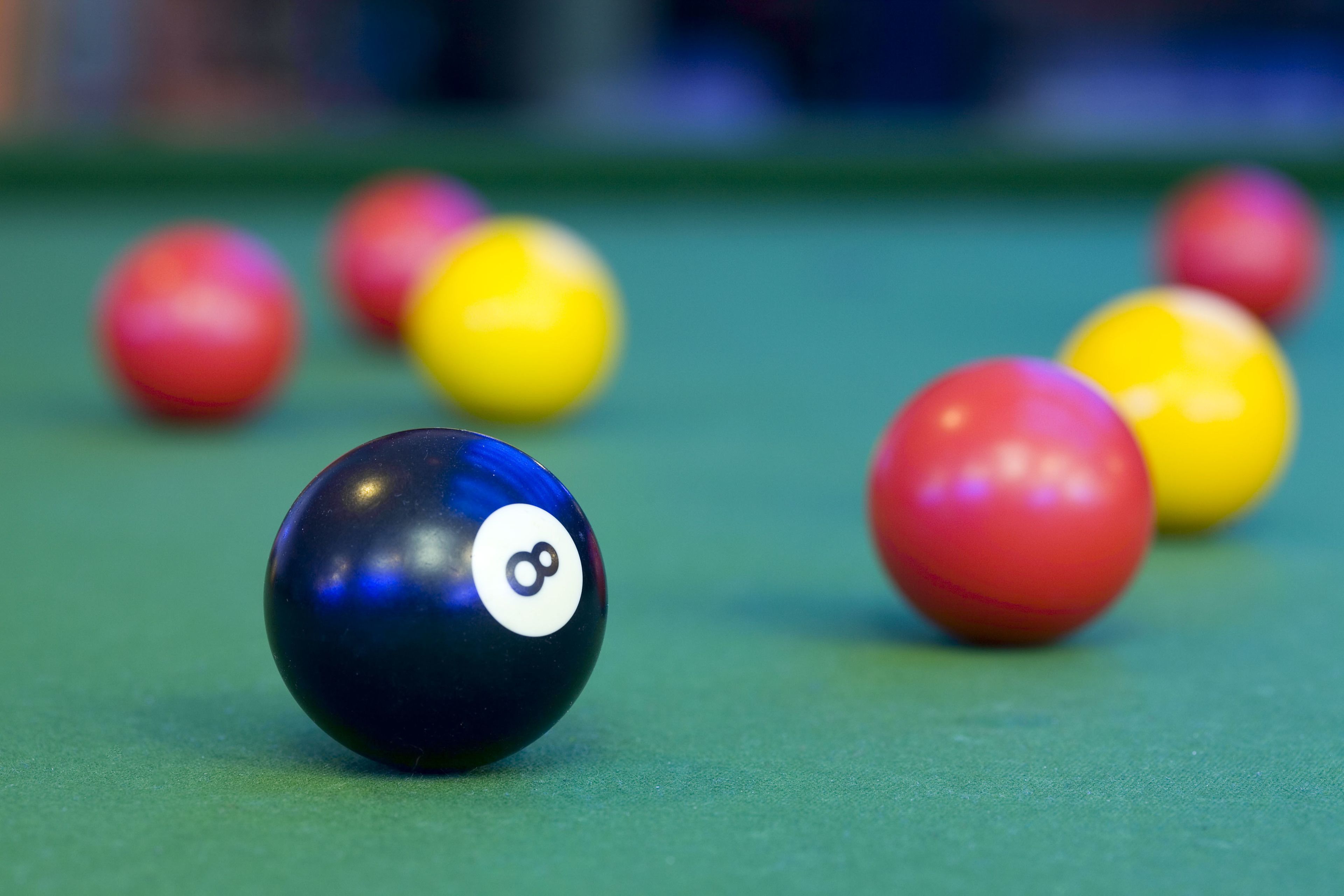 A close-up of a pool table with several billiard balls.