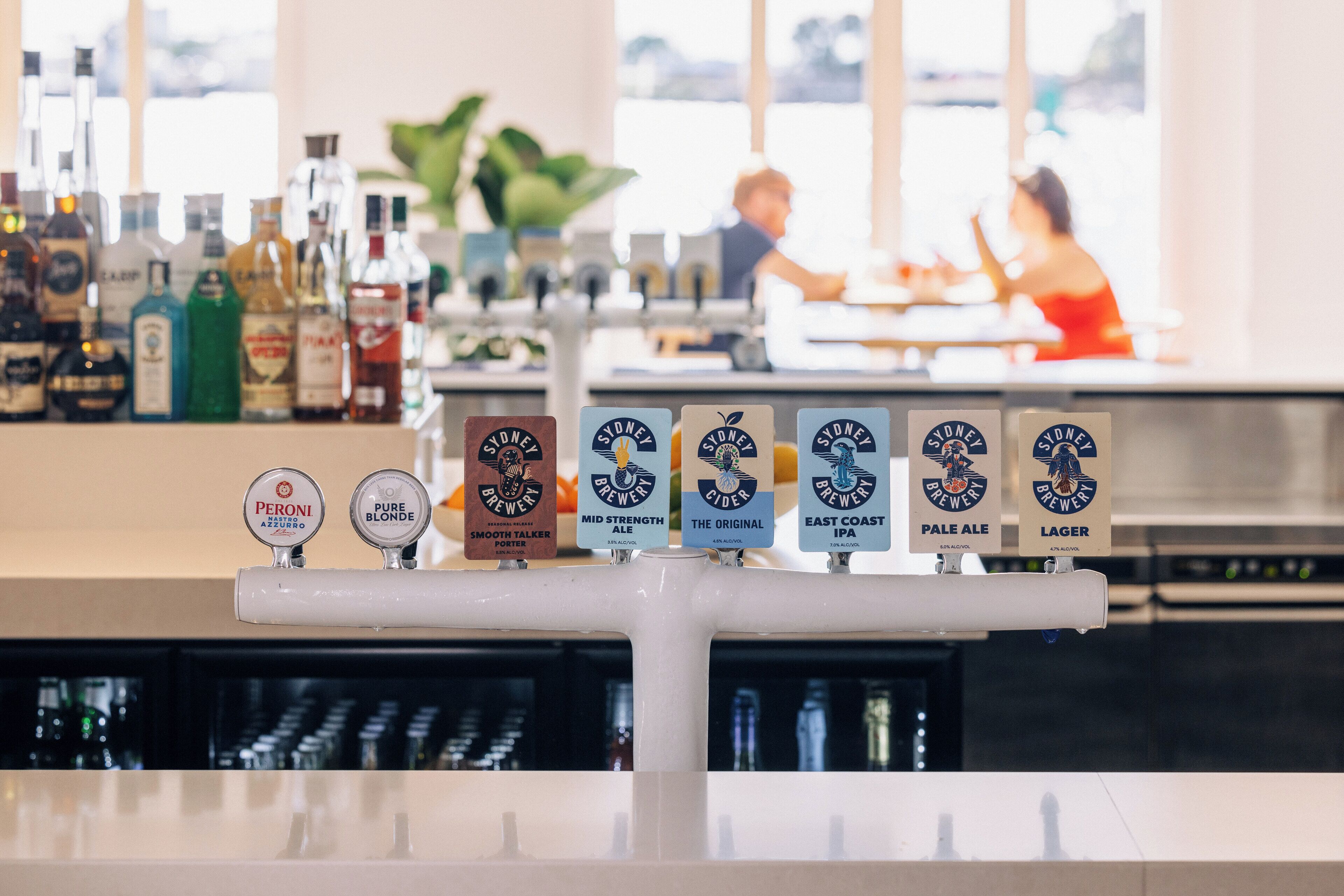 A bar with multiple taps labeled with different beer types.