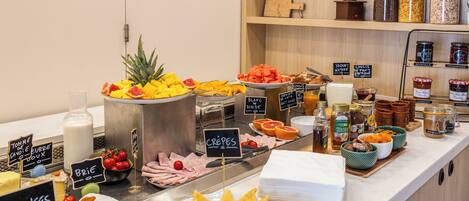 A breakfast buffet with various food items and condiments.