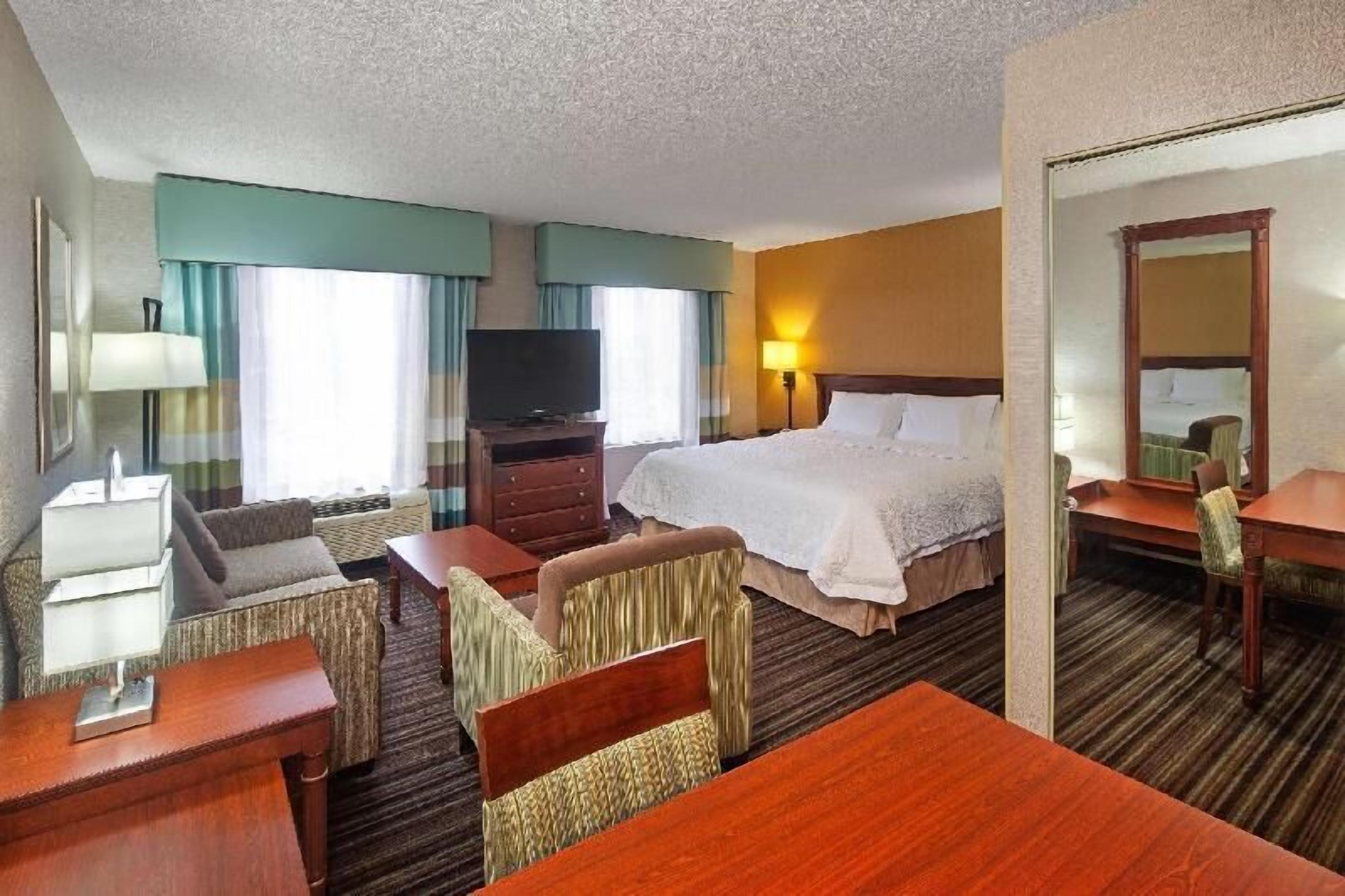 Premium bedding, desk, laptop workspace, blackout drapes