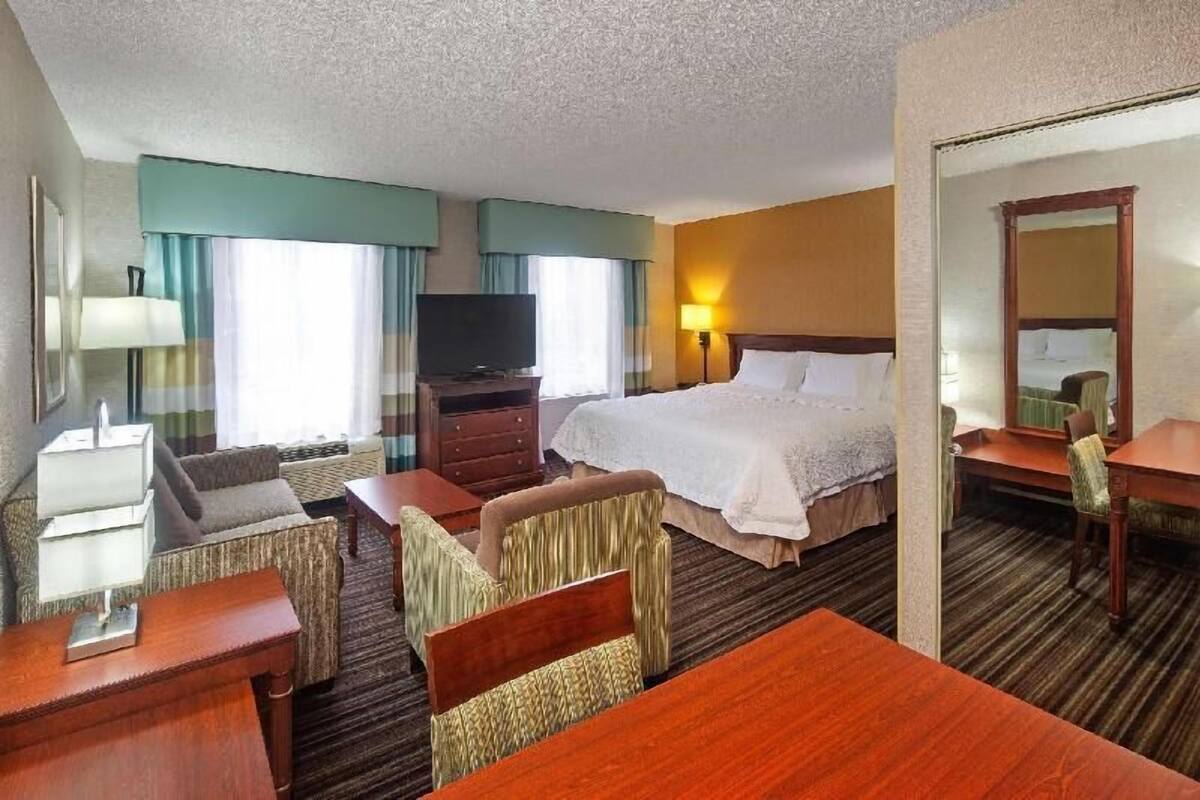 Premium bedding, desk, laptop workspace, blackout drapes