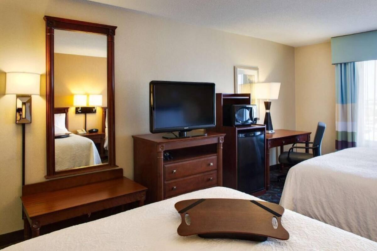 Premium bedding, desk, laptop workspace, blackout drapes