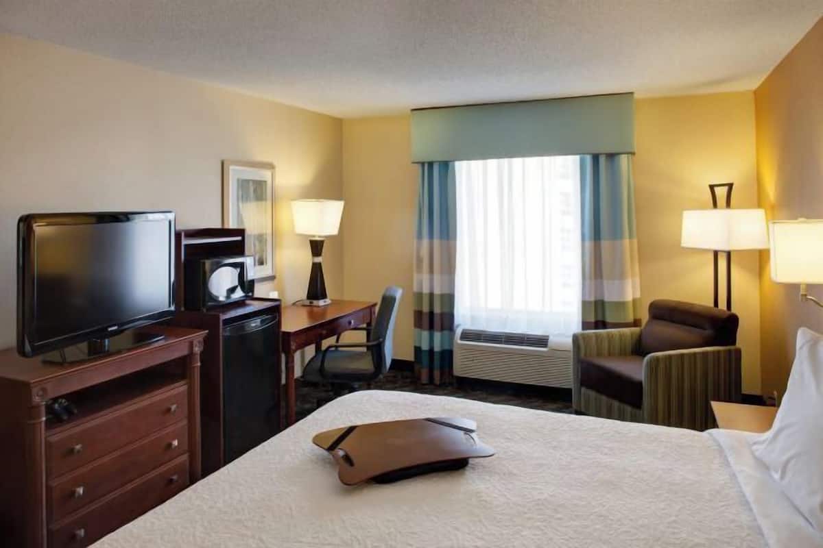 Premium bedding, desk, laptop workspace, blackout drapes