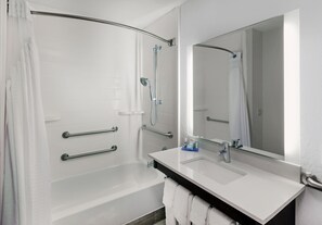 A modern bathroom with a bathtub, a shower, a sink, and a large mirror. - Holiday Inn Express & Suites Houston - Memorial Park Area by IHG (Houston)