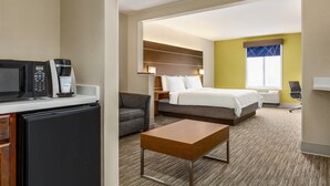 A hotel room with a bed, a desk with a coffee maker, a chair, and a television. - Holiday Inn Express & Suites Philadelphia - Mt. Laurel by IHG (Mount Laurel)
