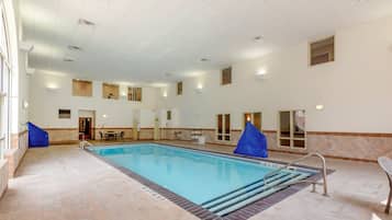 Relax by the rectangular pool surrounded by a tiled floor and steps leading into the water.