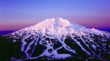 A snow-covered mountain with a clear sky.