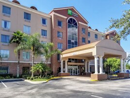 A Holiday Inn Express building with a brick facade, large windows, and a covered entrance.