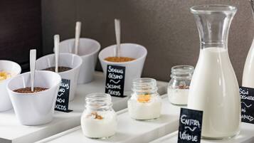 A display of various food items including bowls of seeds and a large bottle of milk.