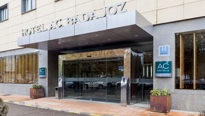 The exterior of a hotel with a prominent entrance, glass doors, and a sign indicating it is part of the AC Hotels Marriott chain. - AC Hotel Badajoz by Marriott (Badajoz)