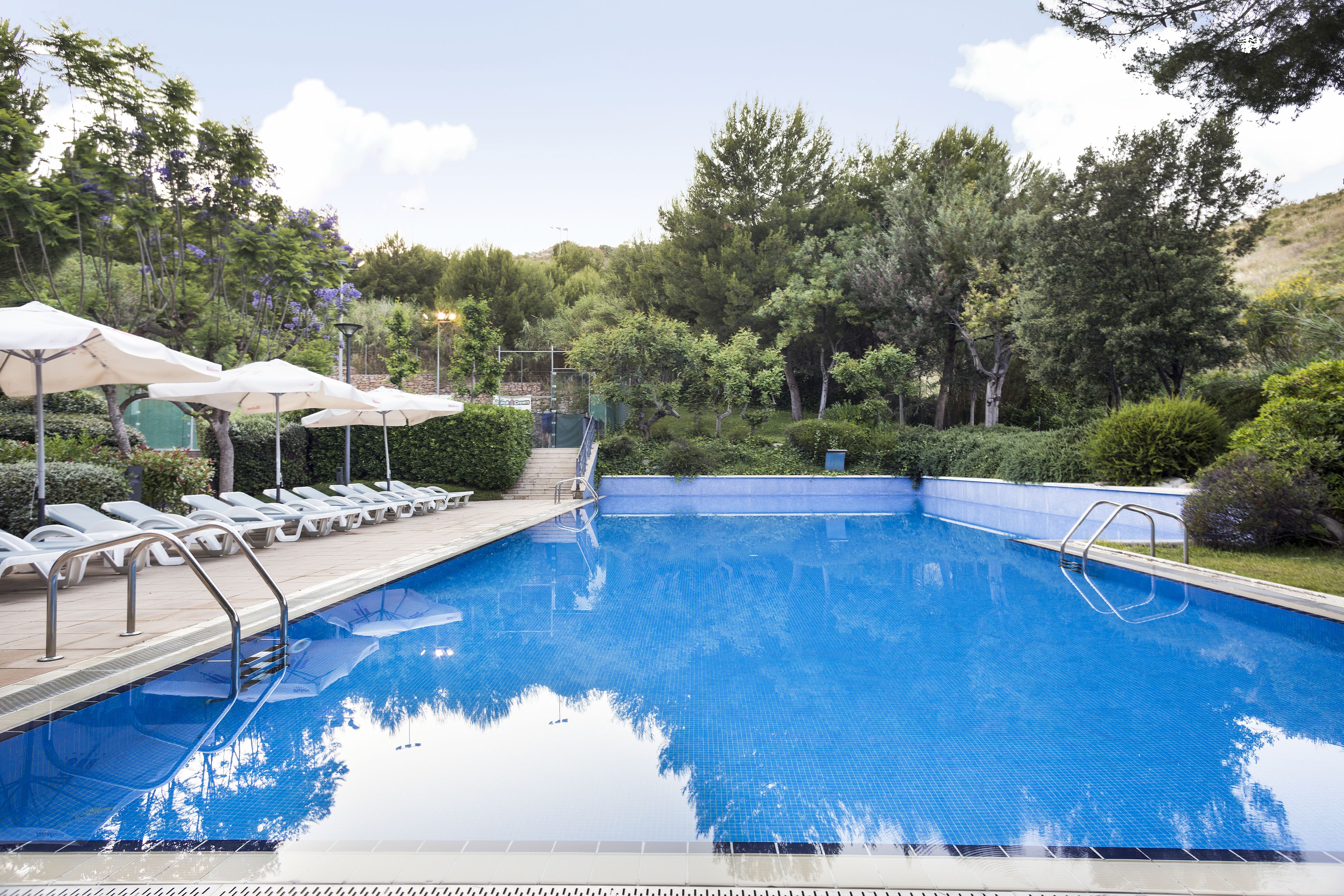 seasonal outdoor pool, open 9:00 am to 9:00 pm, pool umbrellas