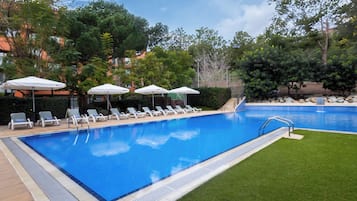 Seasonal outdoor pool, open 9:00 AM to 9:00 PM, pool umbrellas