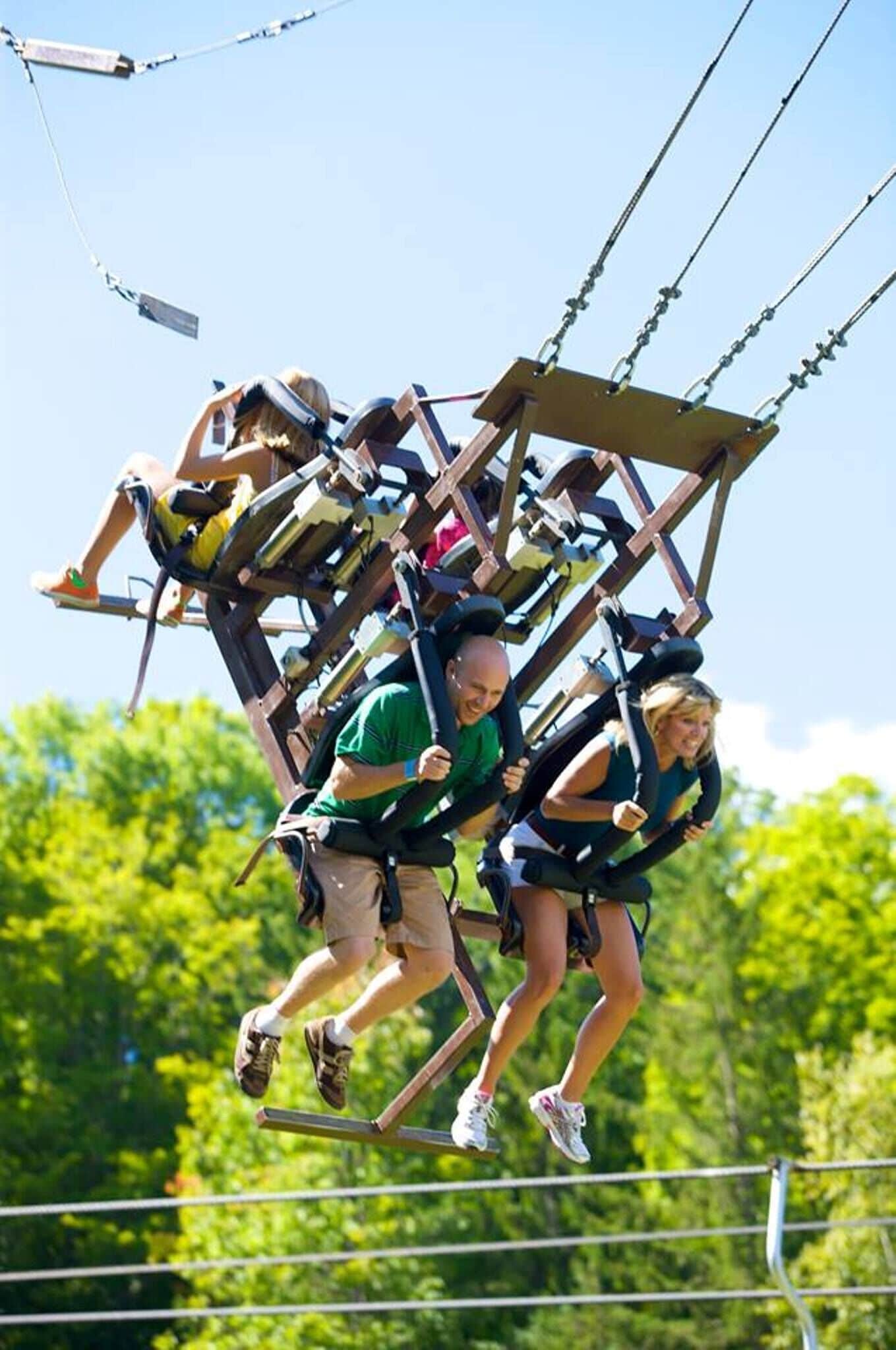 A group of people on a swing ride at an amusement park.