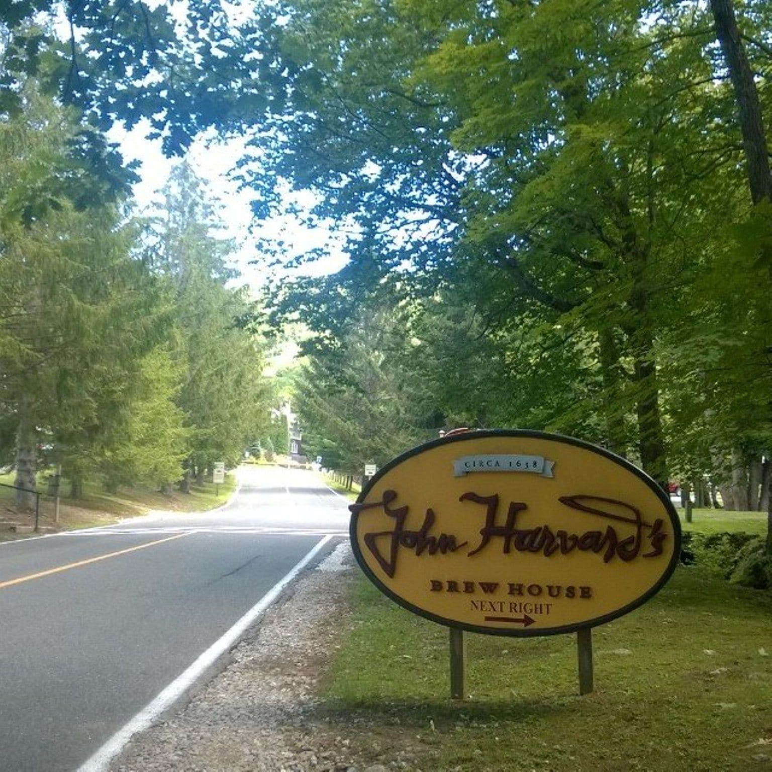 A yellow sign for John Harvey's Brew House indicating it is the next right.