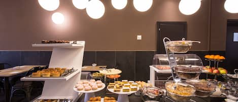 A buffet setup with various food items and a seating area.