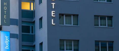 A hotel building with the name "ibis budget" displayed prominently on the facade.