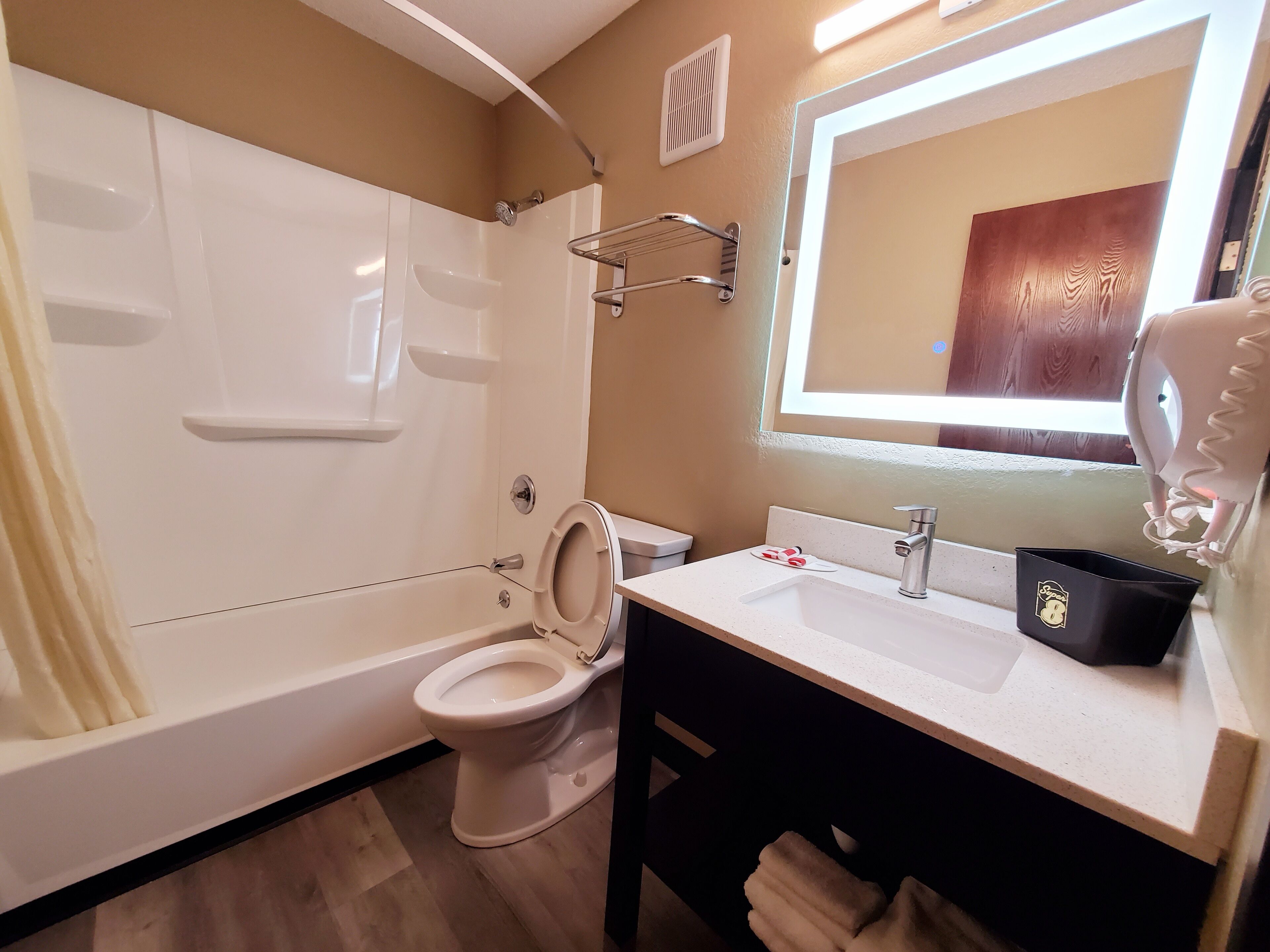 A bathroom with a bathtub, toilet, and sink.
