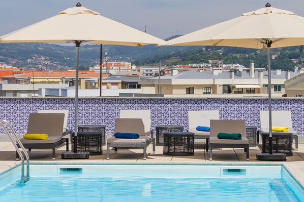 Seasonal outdoor pool, pool umbrellas, pool loungers