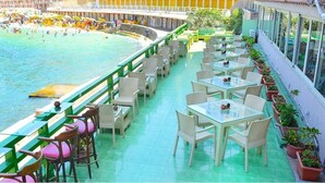 A rooftop bar with outdoor seating overlooking a pool area. - San Giovanni Stanly Hotel & Restaurant (Alexandria)