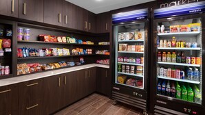 A refrigerated display case stocked with various food items and beverages.