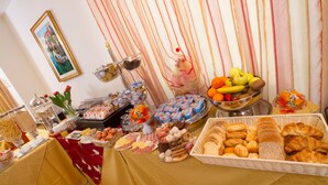 A buffet table with various food items and a decorative backdrop. - Hotel Garibaldi (Mestre)