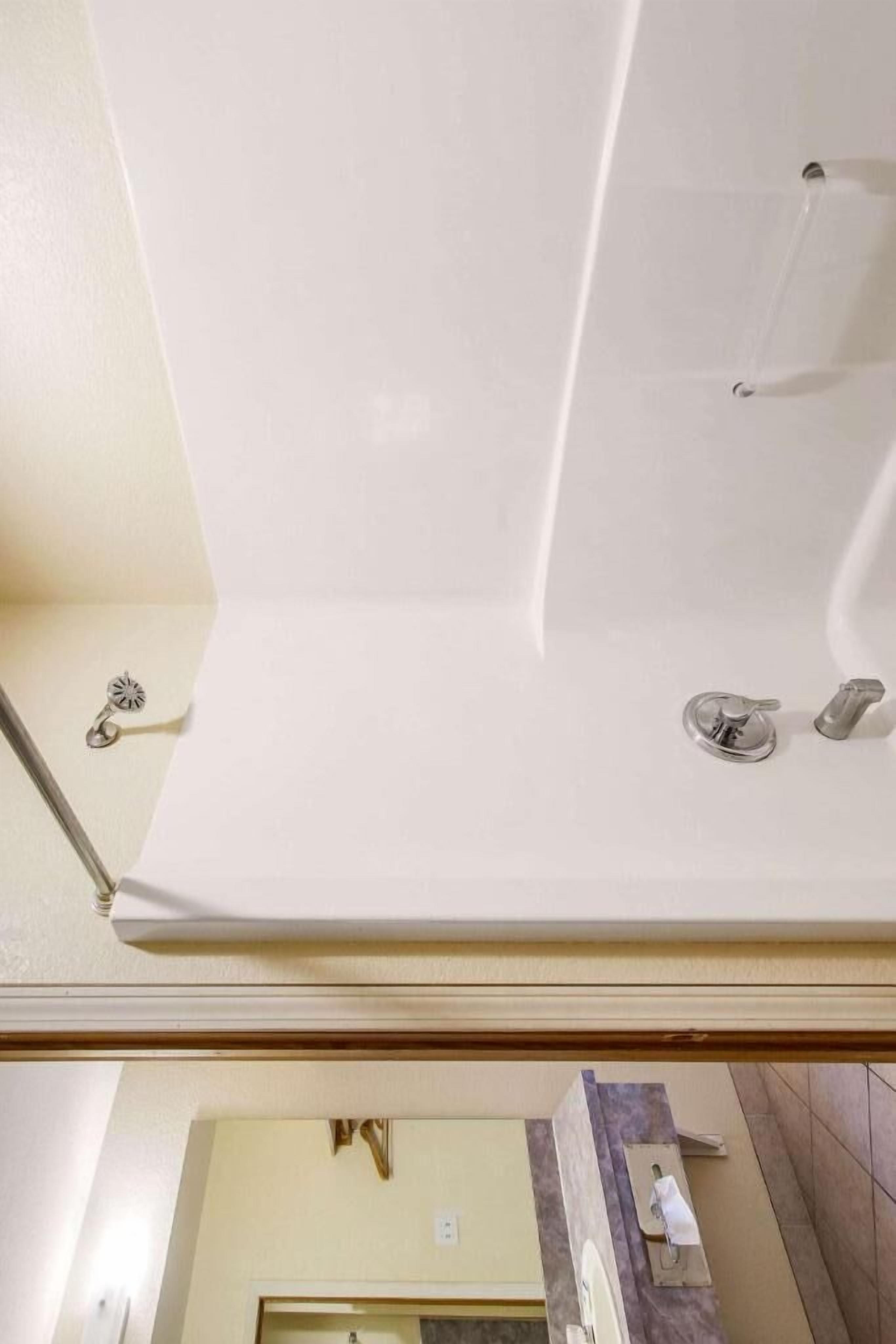 A bathroom with a bathtub, a shower, and a toilet.