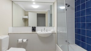 A bathroom with a toilet, sink, and shower. - Oaks Perth Hotel (Perth)
