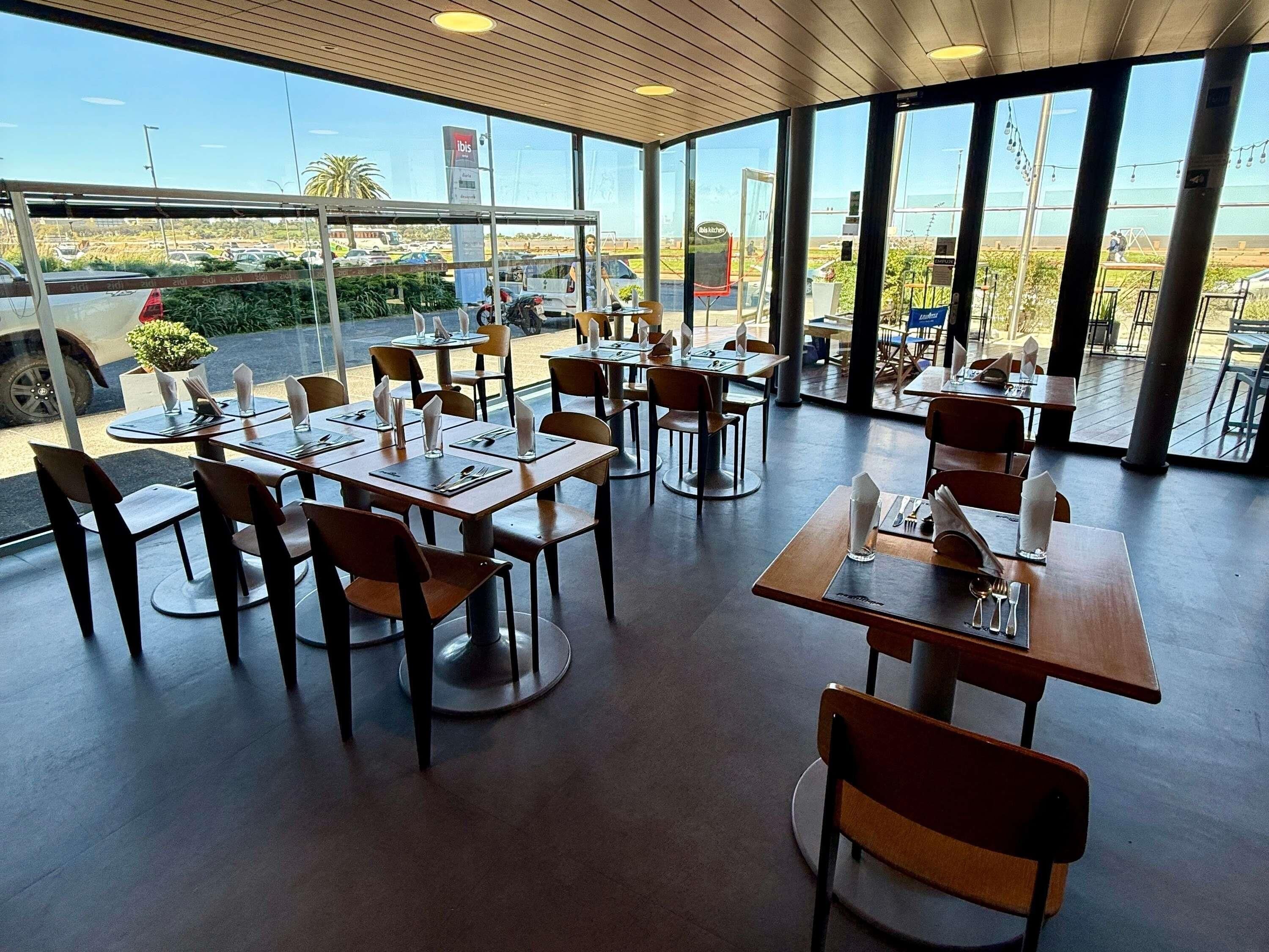 A restaurant with tables and chairs arranged for dining.