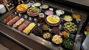 A buffet with various food items including fruits, meats, cheeses, and vegetables. - Novotel Queenstown Lakeside (Queenstown)