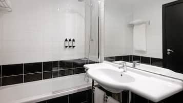 A modern bathroom with a bathtub, a sink, and a shower.