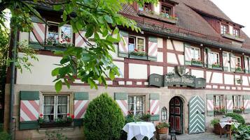 A traditional half-timbered building with a sign reading "Gasthaus Rothner."