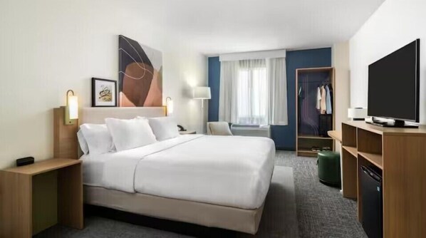Relax in a stylish room with a comfortable bed, flat-screen TV, and ample workspace.