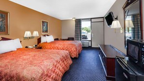 A hotel room with two beds, a desk with a television, a microwave, and a window with curtains. - Days Inn by Wyndham Martin (Martin)