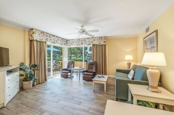 A compact kitchenette with a microwave, toaster, coffee maker, and a trash bin. at Inn at the Beach