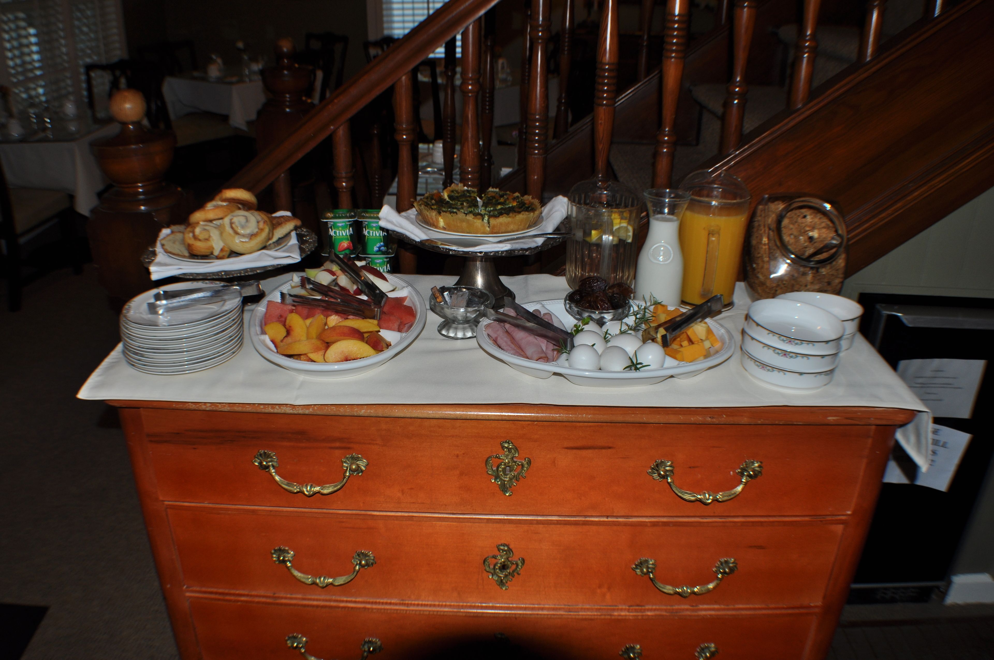 Een ontbijtbuffet met diverse etenswaren en drankjes op een tafel.
