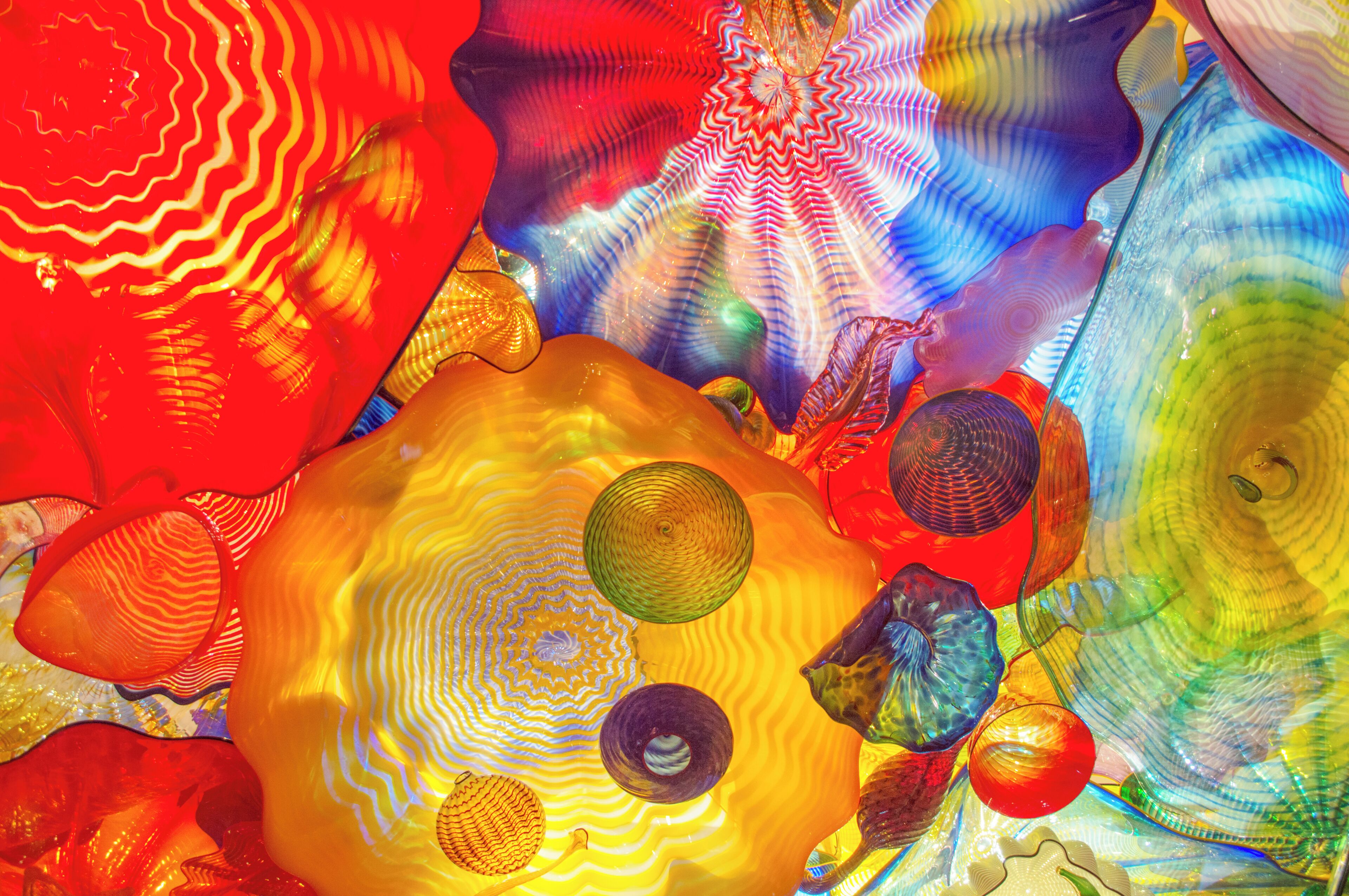 A close-up of colorful glass sculptures with intricate patterns and textures.