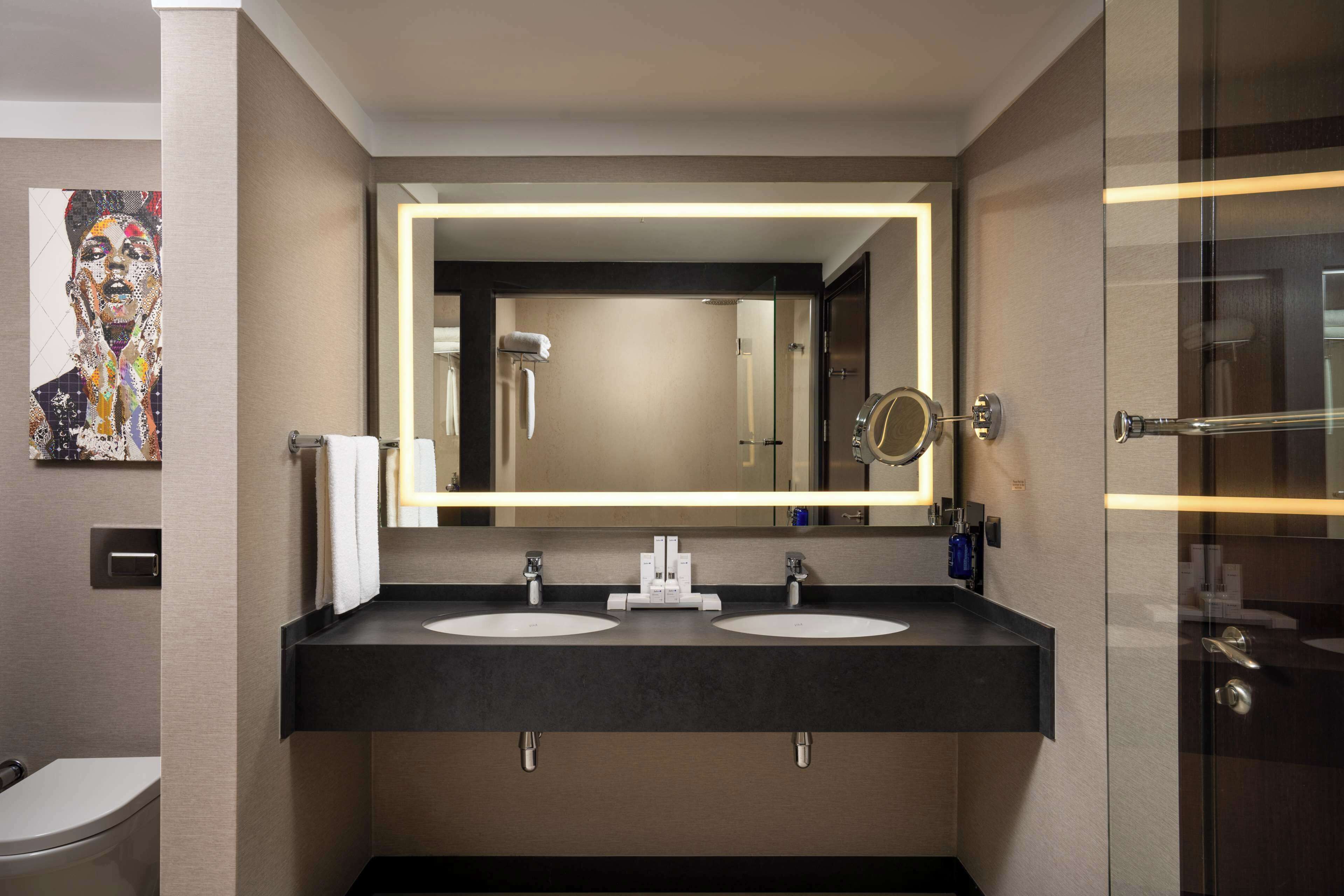 junior suite | bathroom | separate bathtub and shower, rainfall showerhead, designer toiletries