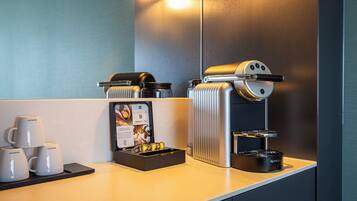 A modern coffee station with a coffee machine, cups, and a menu display.