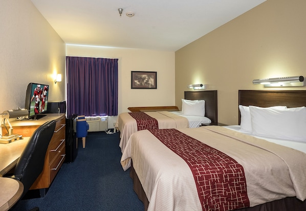 A hotel room with two beds, a desk with a computer, a chair, a TV, and a window with curtains. - Red Roof Inn Jackson, OH (Jackson)