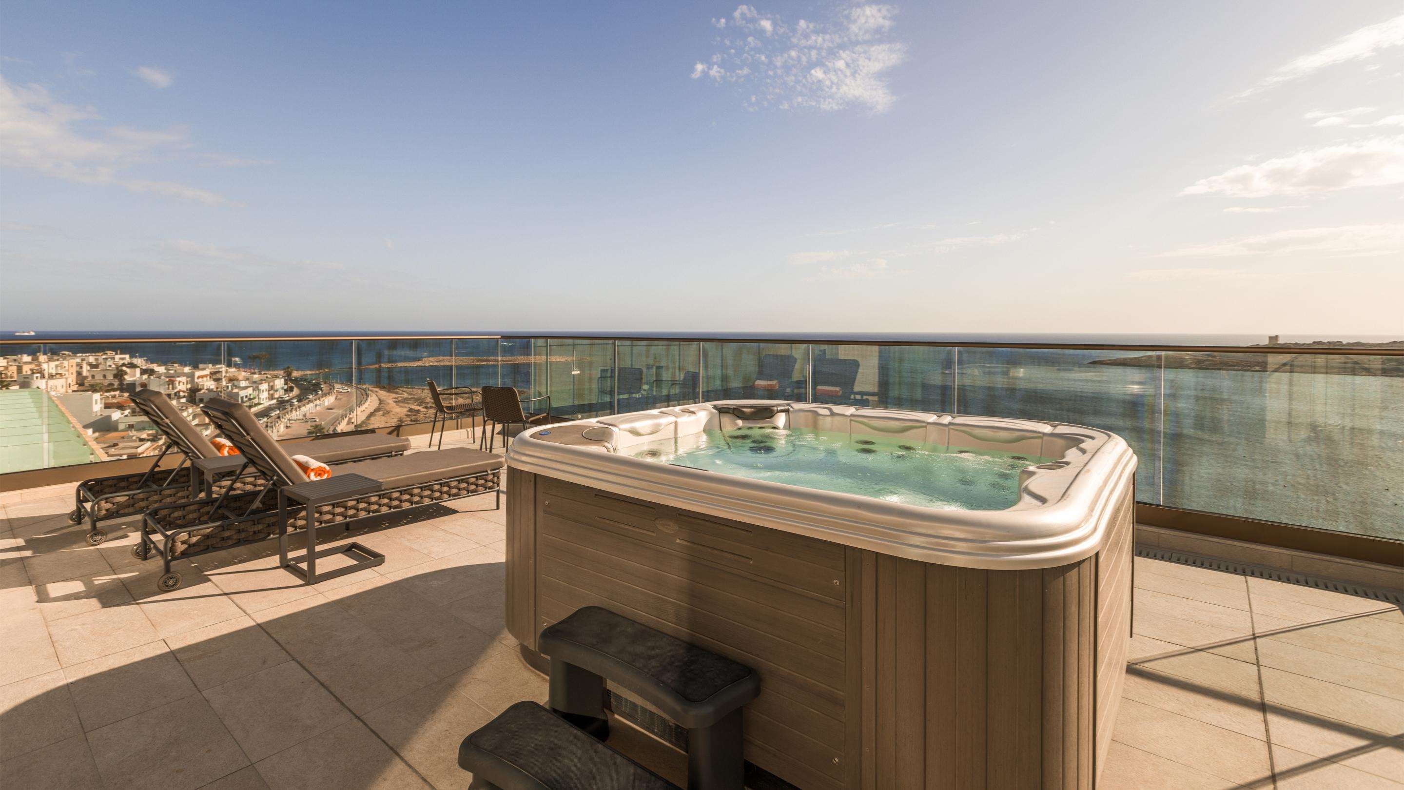 deluxe suite, 1 king bed, hot tub, sea view | 1 bedroom, minibar, in-room safe, blackout curtains