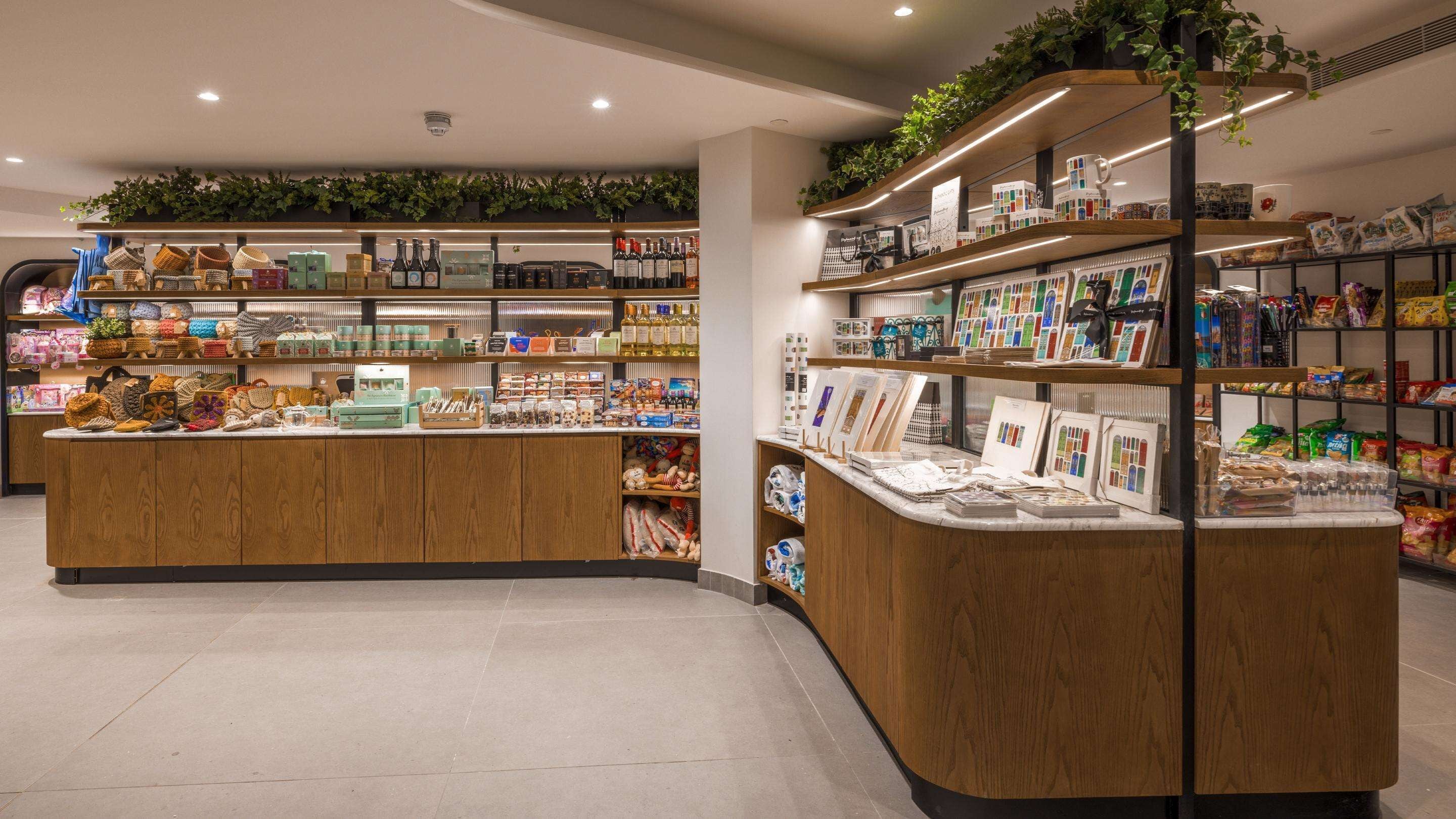 A well-organized retail store with wooden display counters, shelves stocked with various products, and a clean, modern interior.