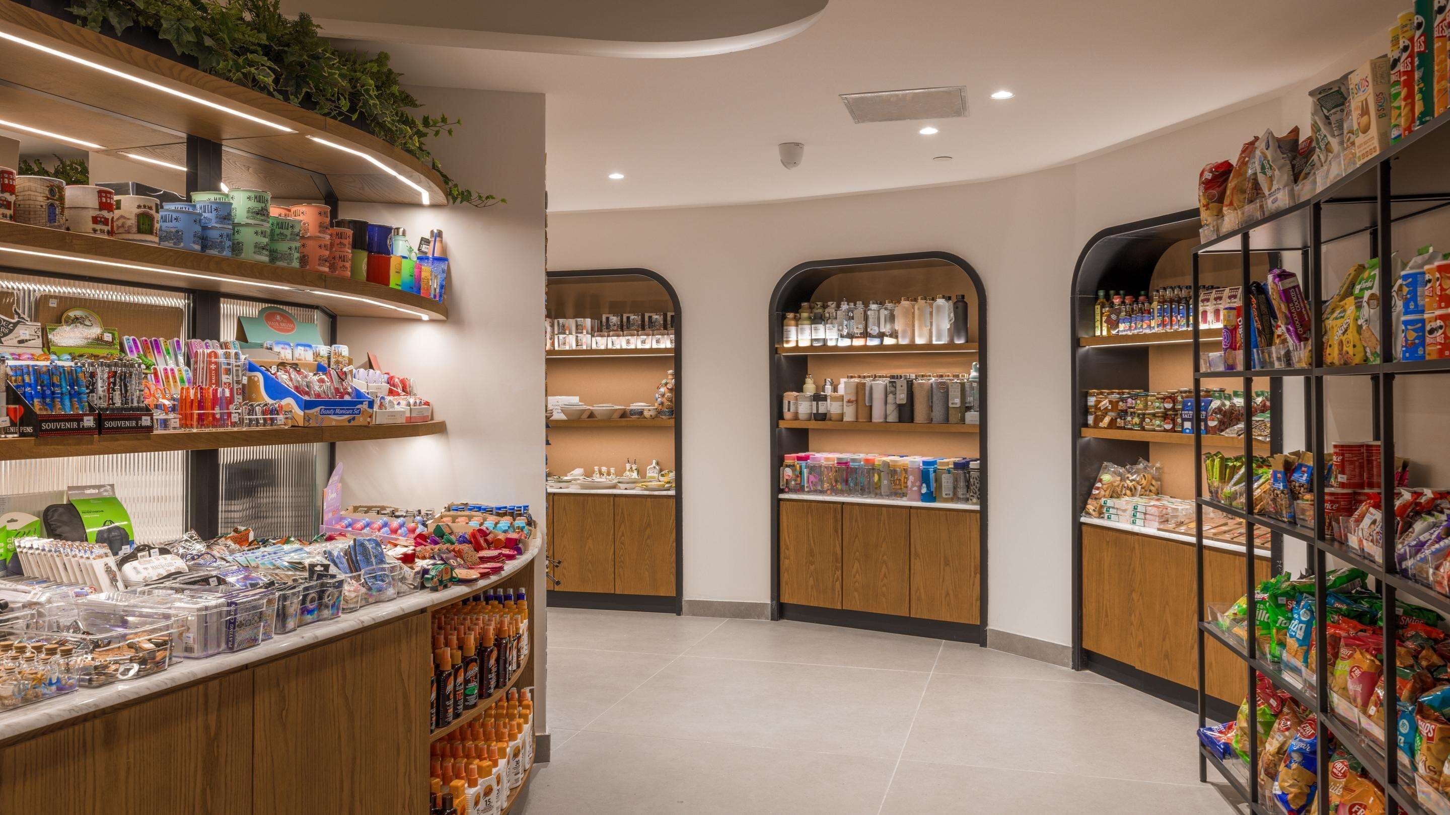 A well-organized retail space with shelves stocked with various products, including food items and household goods.