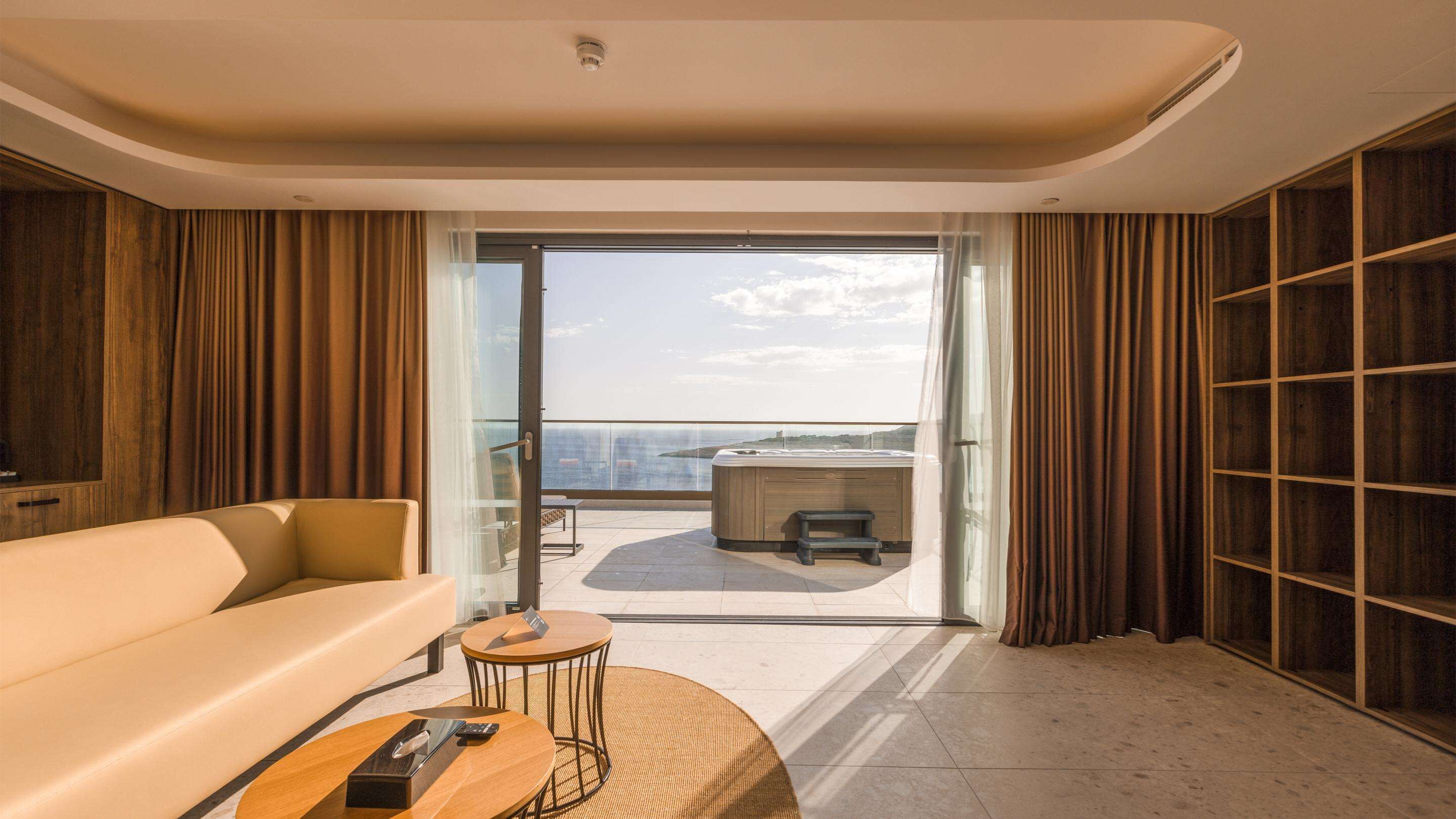 deluxe suite, 1 king bed, hot tub, sea view | 1 bedroom, minibar, in-room safe, blackout curtains