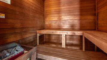 A sauna with wooden benches and a bench with a backrest.