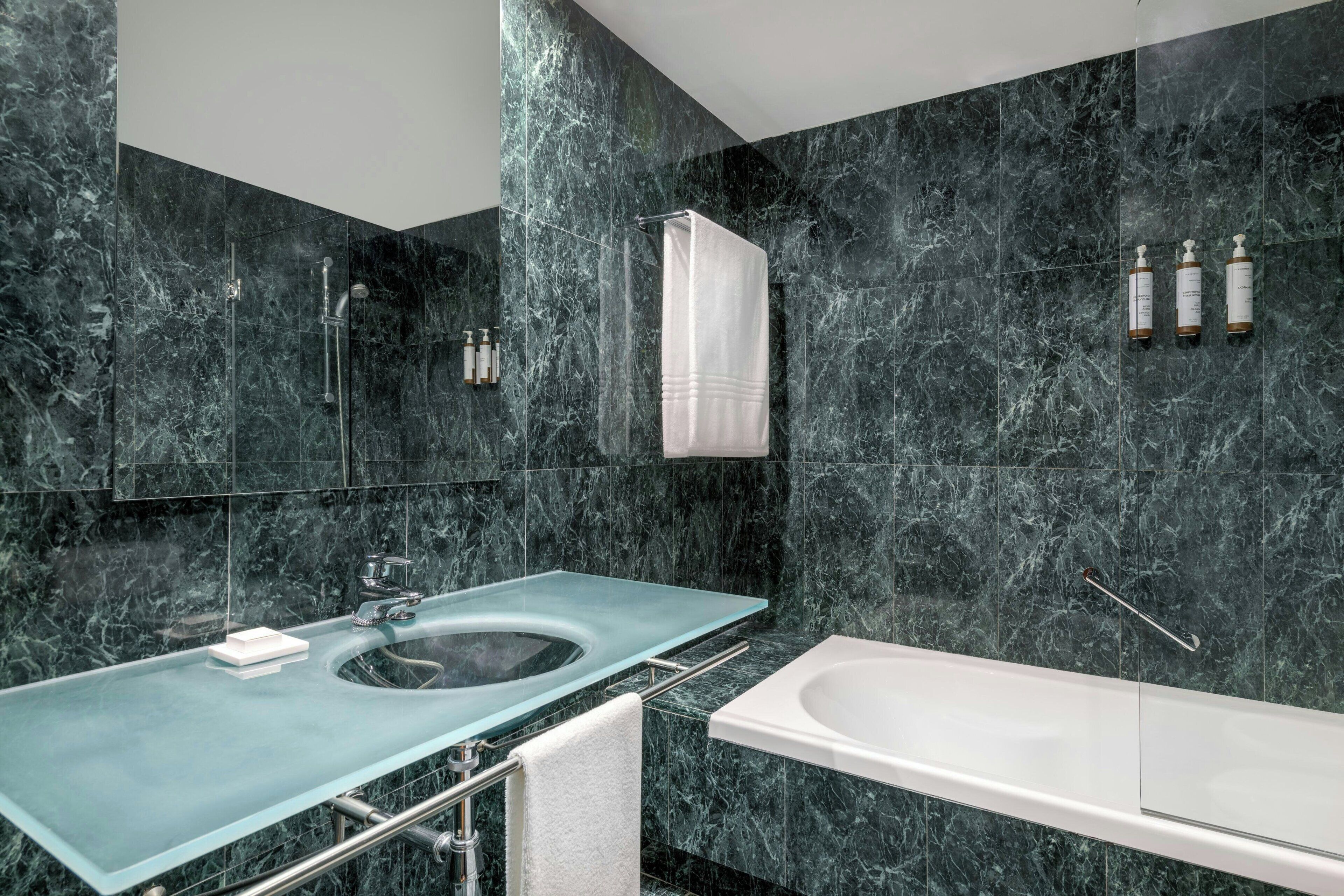 combined shower/bathtub, designer toiletries, hair dryer, towels